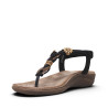 Sandalias planas Amarpies negras con apliques de madera redondos y en forma de flor